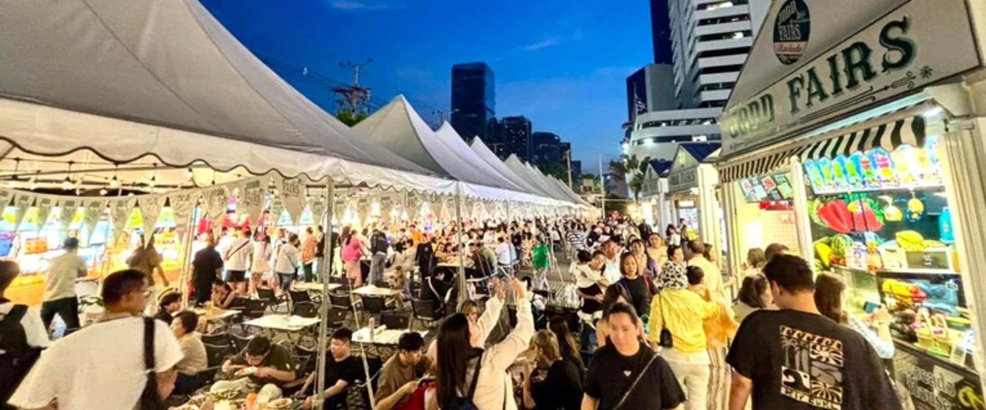 White food tents and evening diners at JODD FAIRS Ratchada, Bangkok.