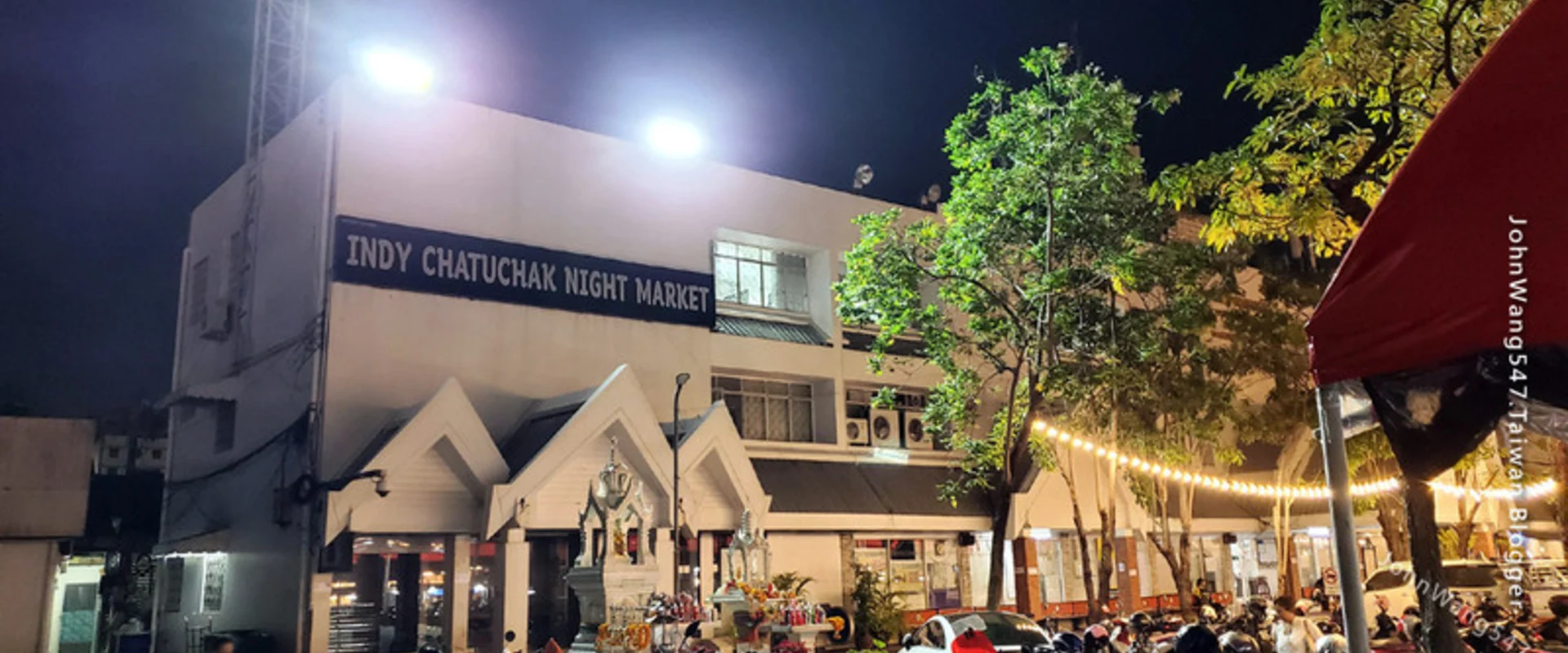 The illuminated Indy Chatuchak Night Market building and entrance in Bangkok.