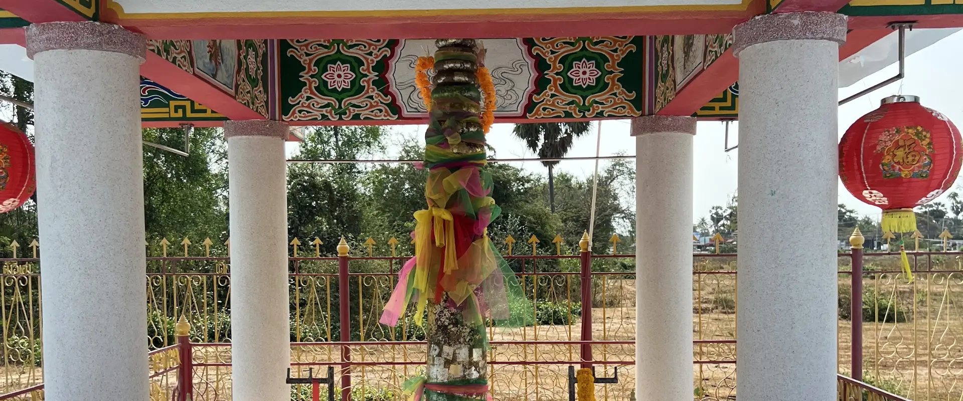 The ribbon-wrapped city pillar inside its pavilion at Pran Buri City Pillar Shrine, Pran Buri, Thailand
