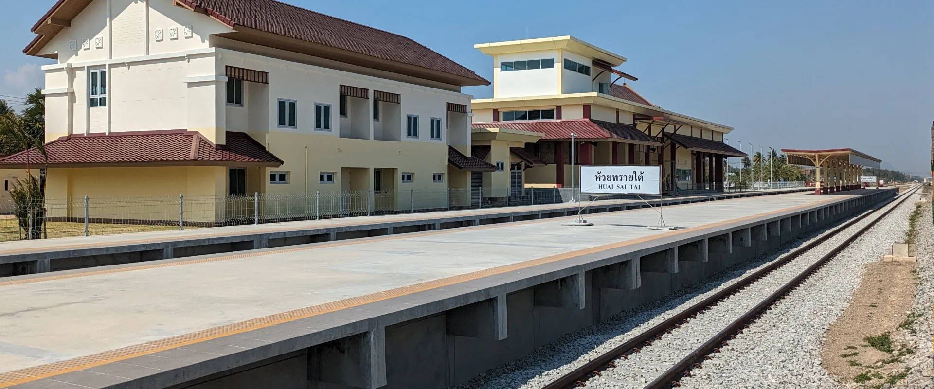 Huai Sai Tai railway station building, platform and bilingual station sign in Cha-am.