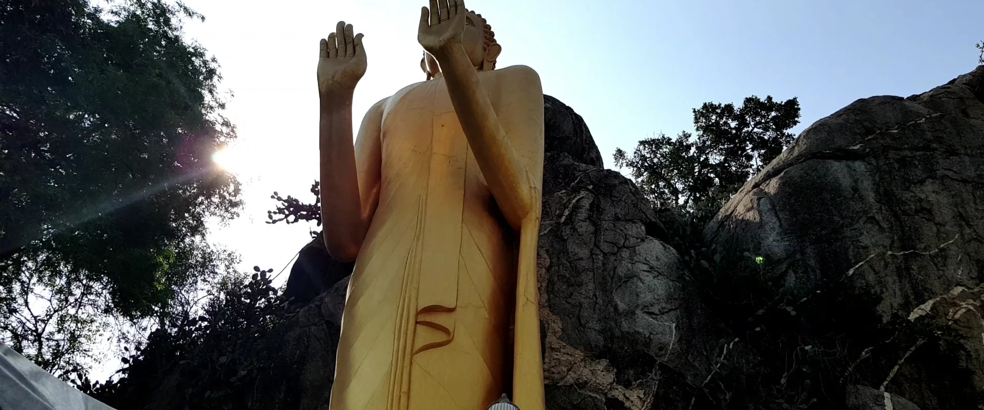Standing Golden Buddha beside the rocks at Khao Takiap, Nong Kae, Hua Hin