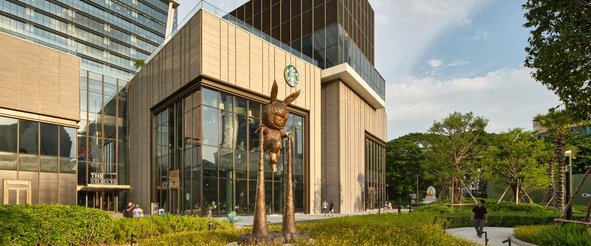 Landscaped paths, trees and a public sculpture in Wireless Park beside The Storeys at One Bangkok